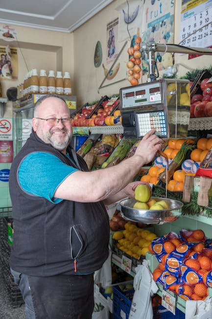 local market vendor weighing oranges
