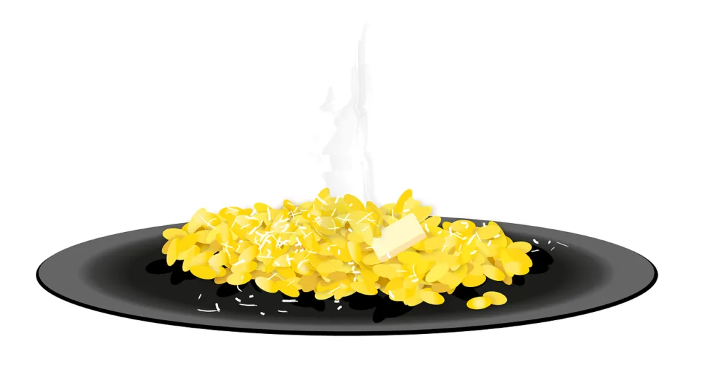 Schwarzer Teller mit dampfendem Safranrisotto, Butter und geriebenem Käse