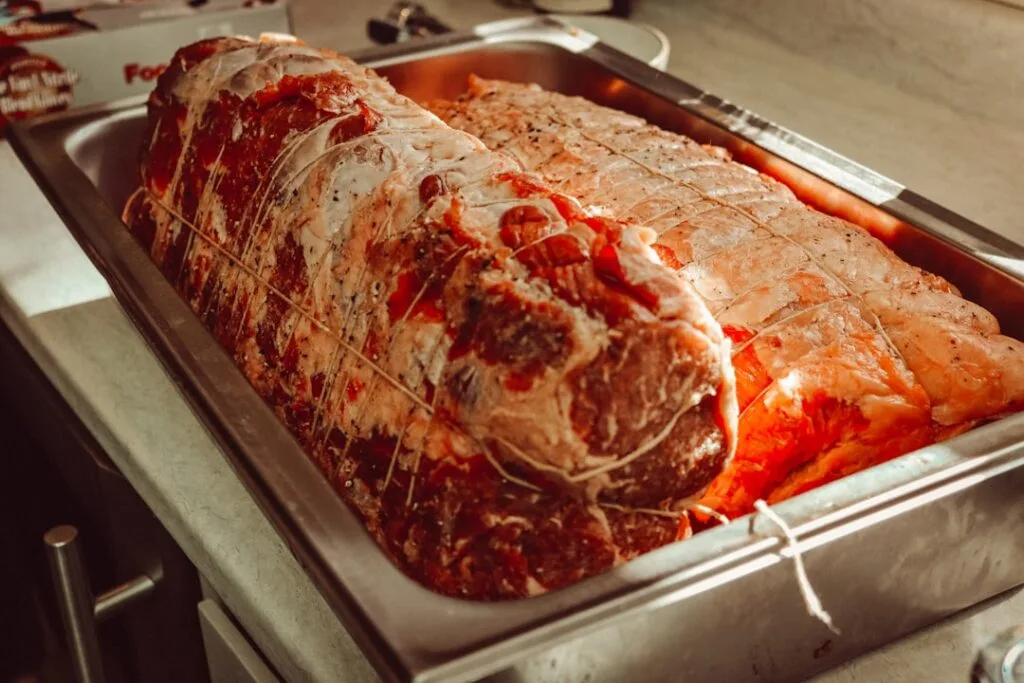 Gewürzter, gebundener Braten in Metallform, bereit für den Ofen