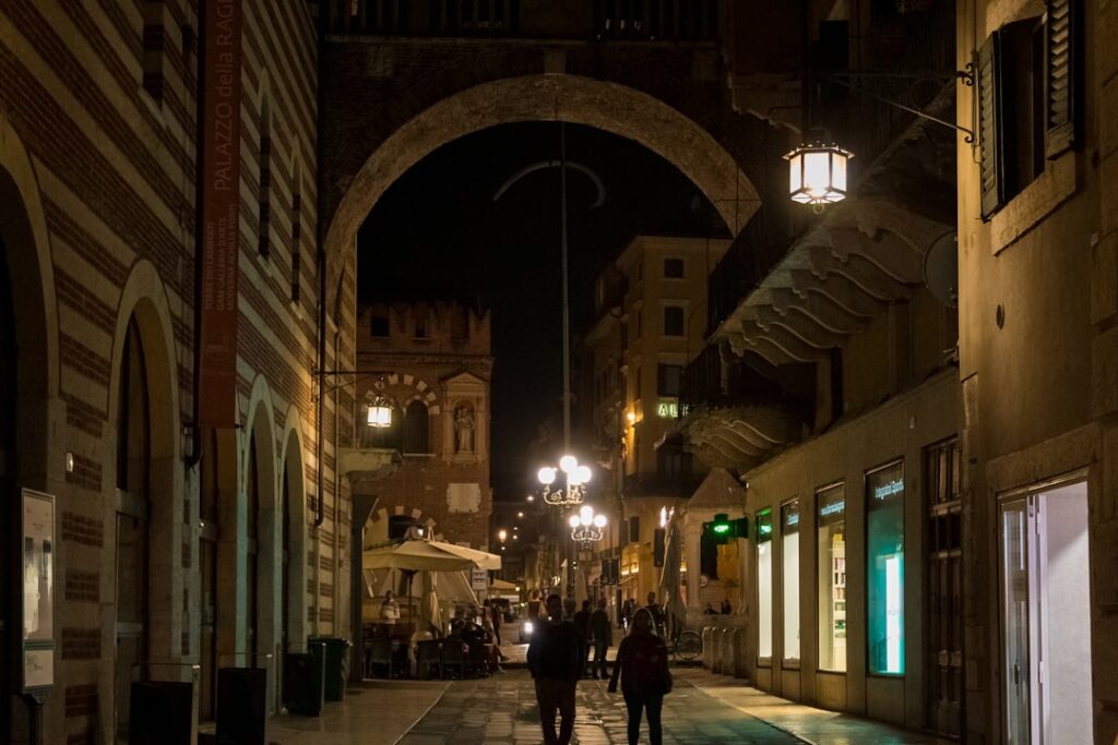 Verona narrow street evening walkers