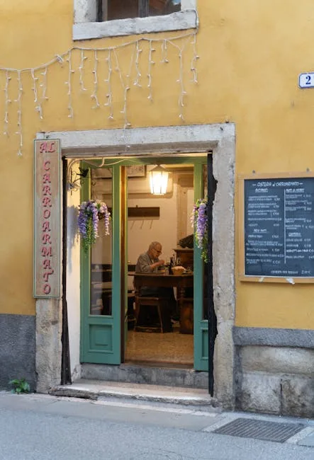 Façade jaune d'une osteria à Vérone avec homme à l'intérieur